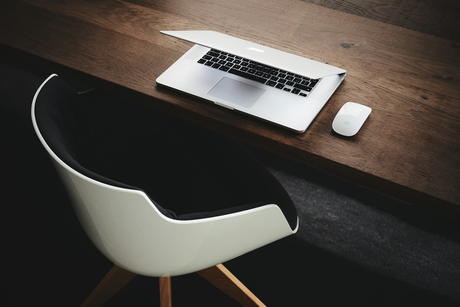 Aufgeräumter Schreibtisch mit Laptop und Maus